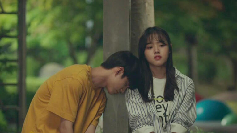 Fate black haird guy in yellow shirt leaning on the shoulder of a girl